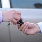 man hands the keys to the car