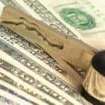 Money with car keys representing loan