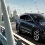 Kia Sportage driving on a bridge