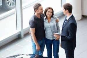 Young couple talking to salesperson