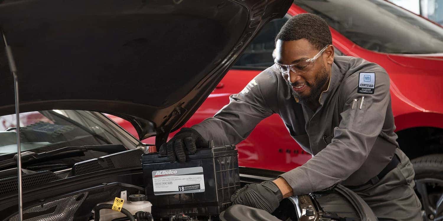 Chevrolet technician performing scheduled Chevy maintenance at DeNooyer Chevrolet in Colonie, NY, near Albany.