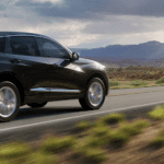 black acura driving by mountains | Findlay Acura