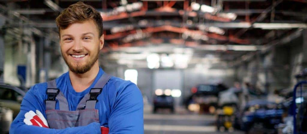 Cheerful serviceman in a car workshop 91820782 original