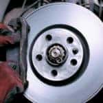 Technician changing brake pads