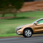 Copper Mercedes-Benz SUV driving on country highway