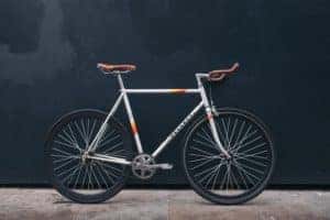 Peugeot bicycle upright on sidewalk