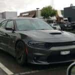 black dodge charger srt on a towing ramp