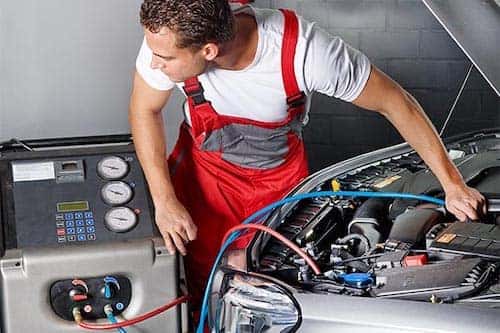 technician repairing AC