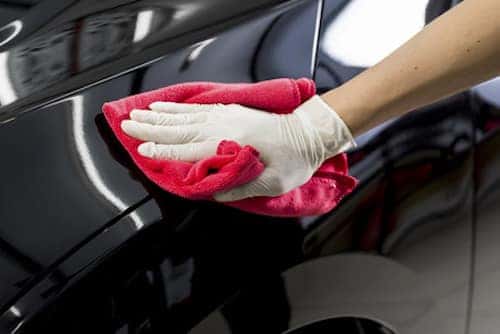 Closeup of hand cleaning black car