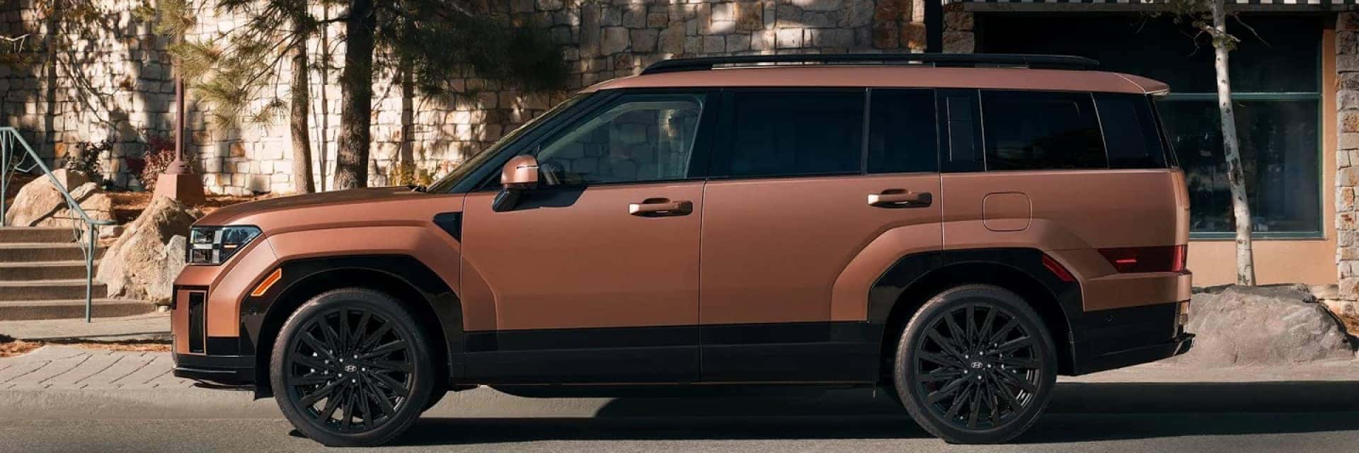 copper 2025 Hyundai Santa Fe driving through town