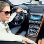 A woman backing up in the 2021 Jaguar F-Type available near Bellmore.