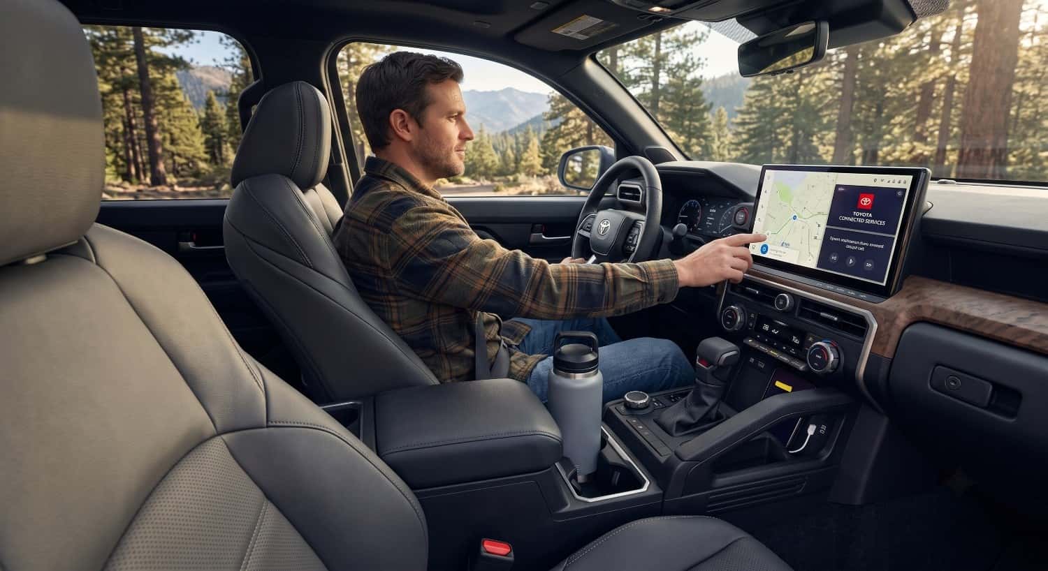 Modern Toyota Tacoma interior dashboard showing spacious front seating, digital display, and ergonomic cockpit design.
