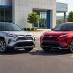 2026 Toyota RAV4 Hybrid SUVs parked outside a dealership, showing front design and MPG fuel economy
