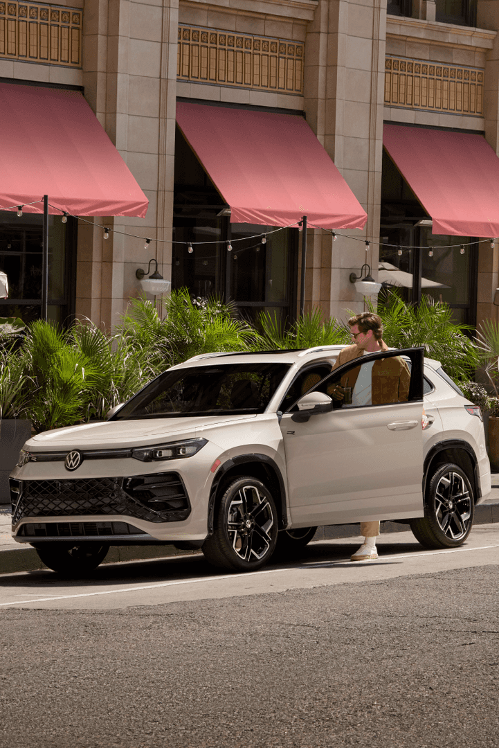 two people standing by a car