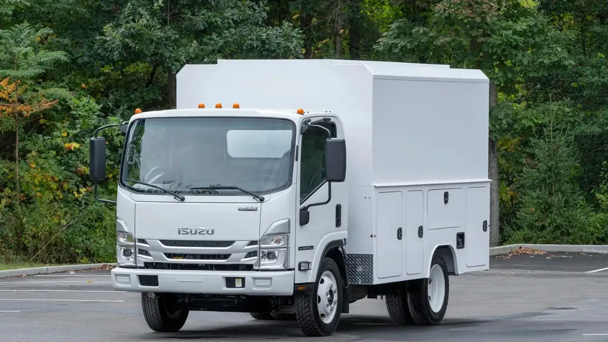 A white Isuzu NPR in a parking lot