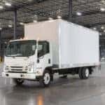 A white Isuzu truck in a warehouse