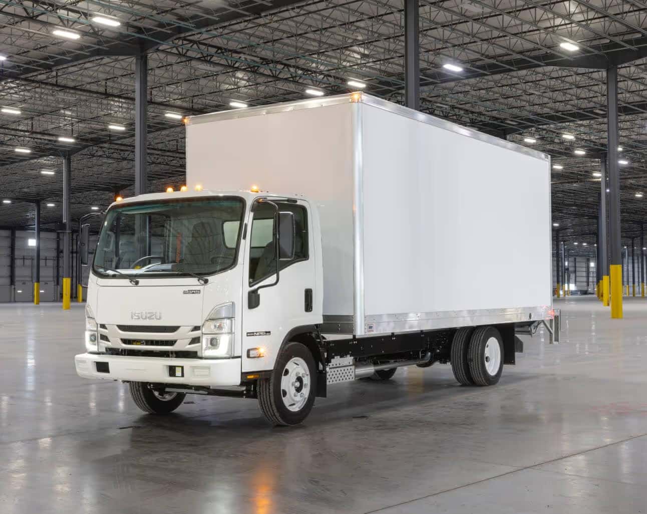 A white Isuzu truck in a warehouse