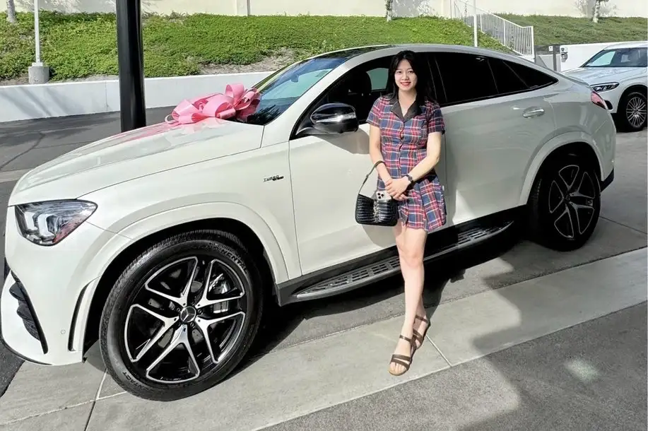 Happy woman who just purchased white GLE Coupe