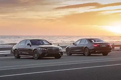 Two S-Class Models Looking Over Ocean