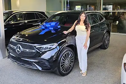 Happy woman who just purchased black GLC