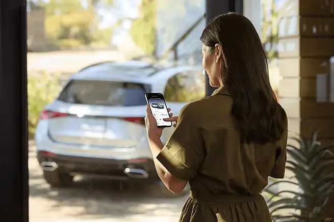 Woman Checking Mercedes-Benz App on iPhone