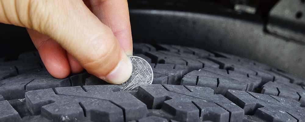 Person measuring tire depth