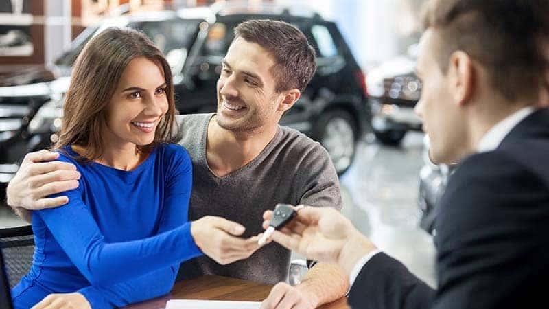 Couple Getting Keys from Salesman