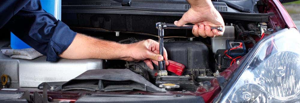 Mechanic Replacing Vehicle Parts at Service Center