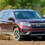 Red 2020 Honda Pilot with AWD drifting in dirt
