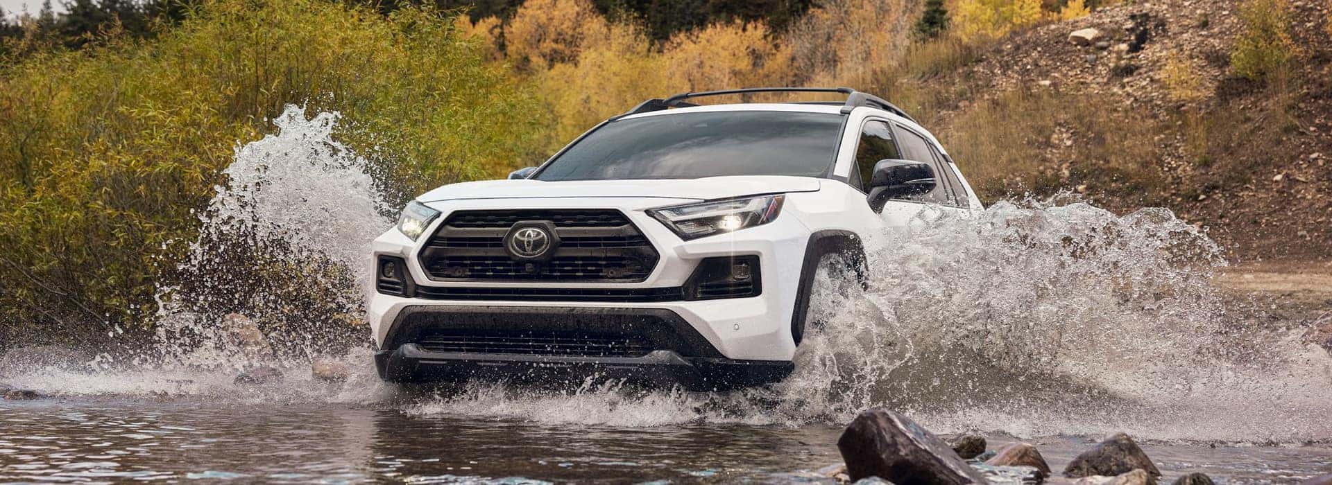The new New Toyota RAV4 driving through a river.