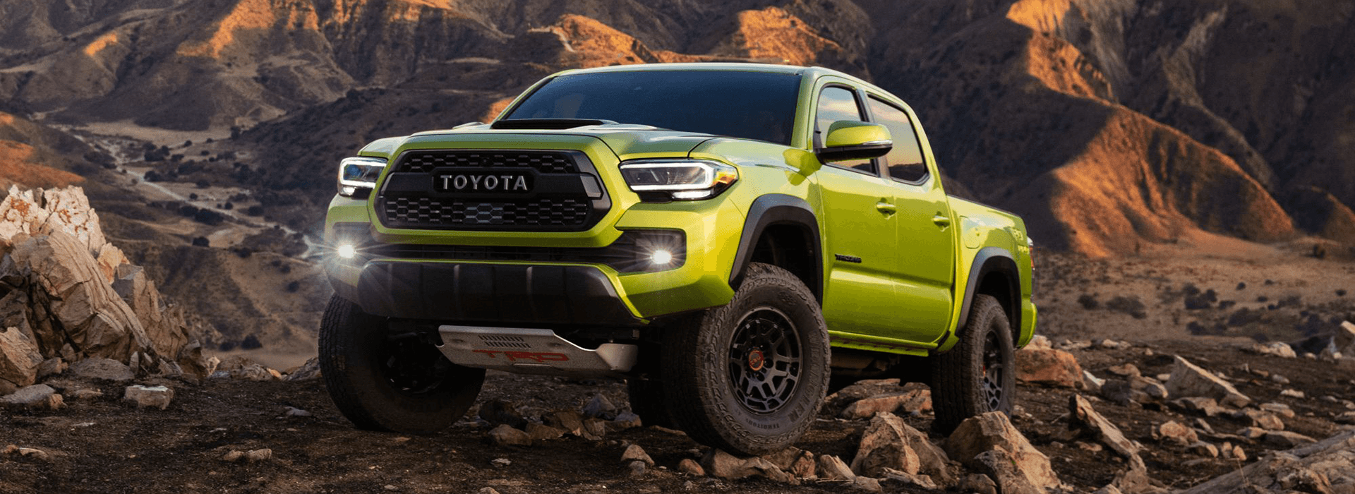 The new 2022 Toyota Tacoma in lime green in the mountains.