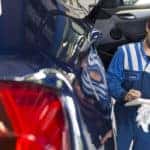 Mechanic going over a recall checklist with a driver