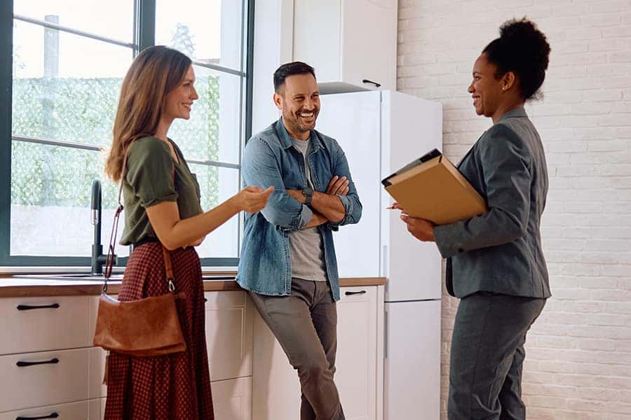 man and woman talking to a realtor