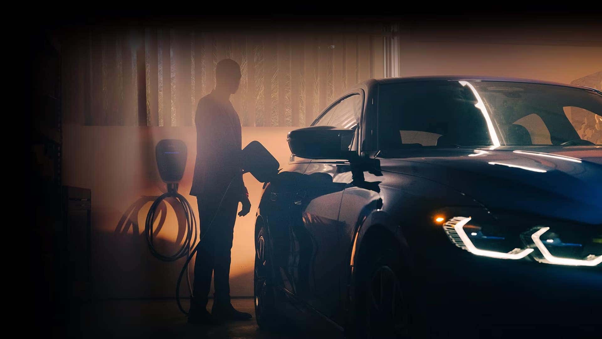 Person charging BMW EV at home