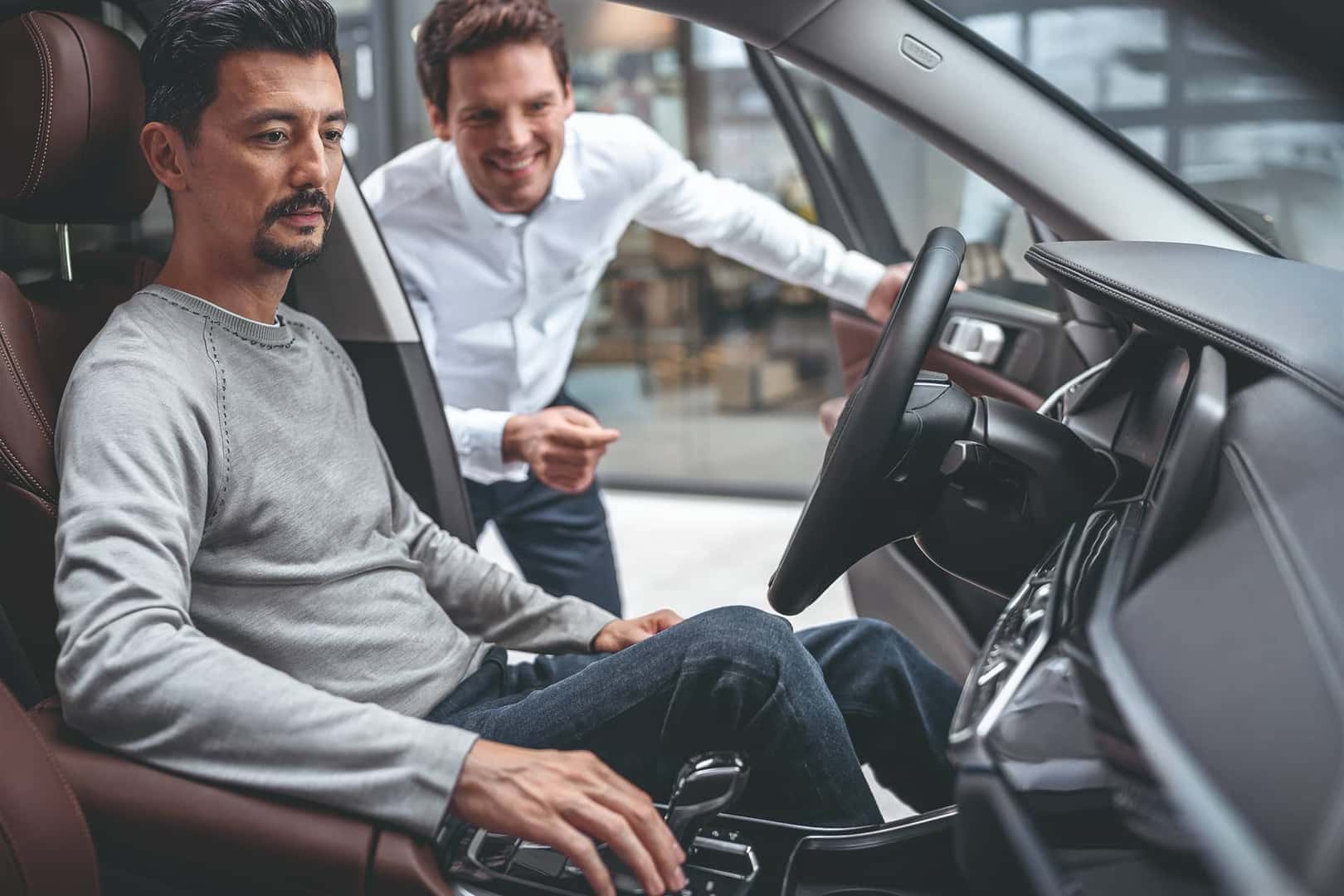 bmw service tech looking at vehicle