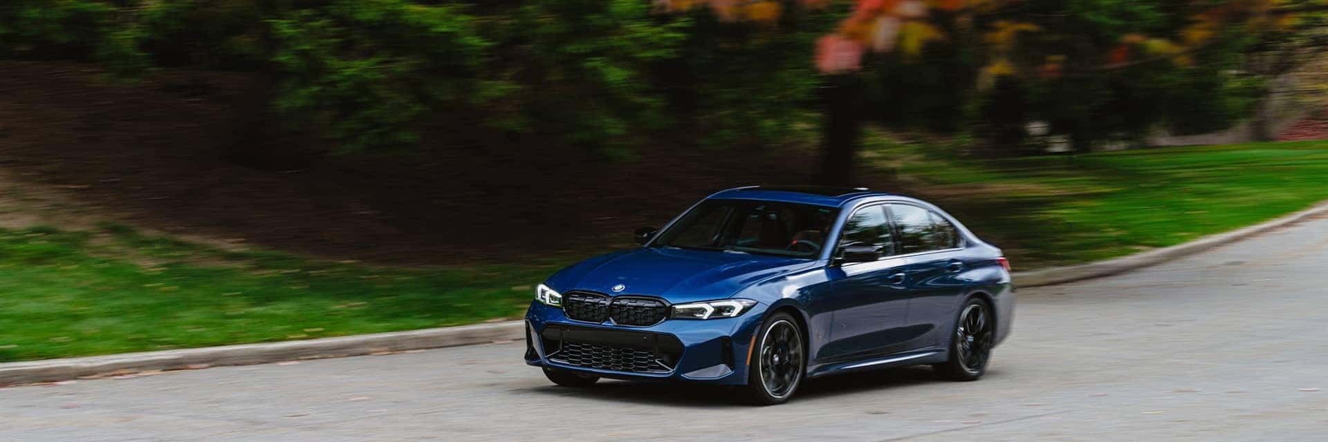 2026 bmw 3 series driving on road in fall