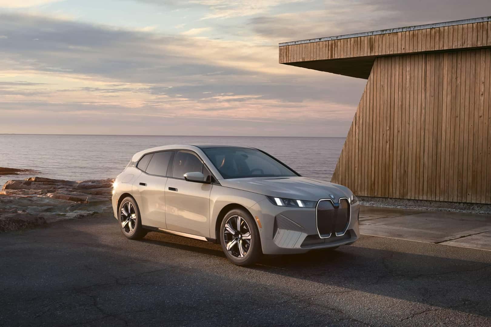 2026 bmw ix parked by home in front of water