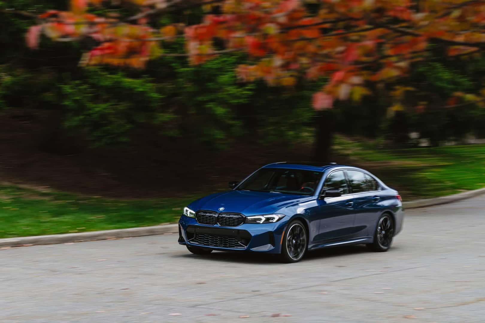 2026 bmw 3 series driving on road in fall
