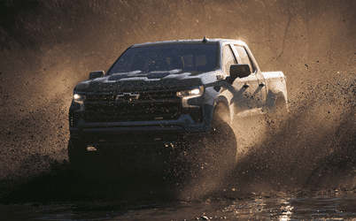 Silverado 1500 driving through mud puddle