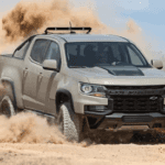 Chevy truck driving in the dirt kicking it up