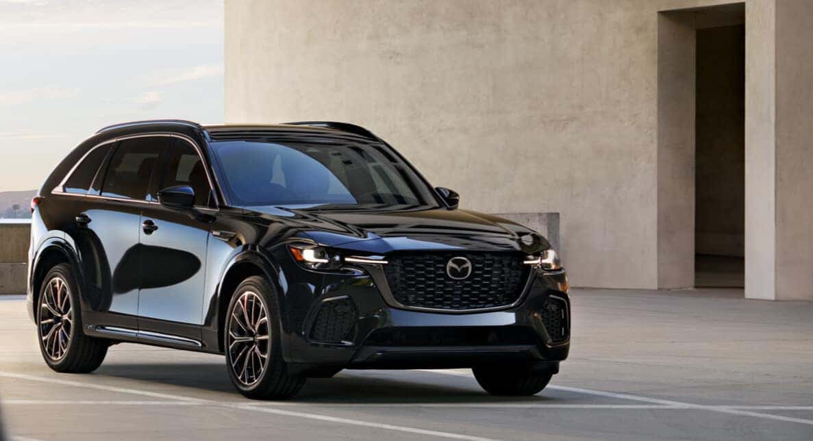 A 2025 Mazda CX-70 parked next to a minimalist beige building