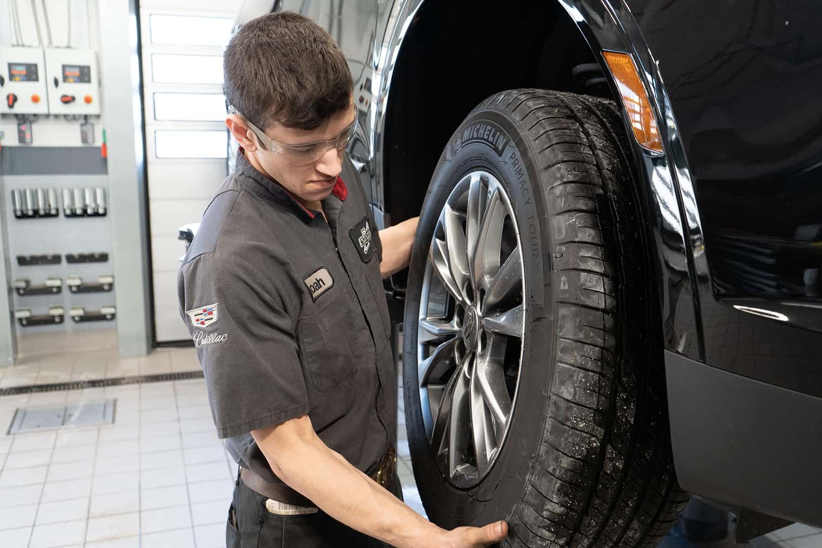 Cadillac Technician removing tire