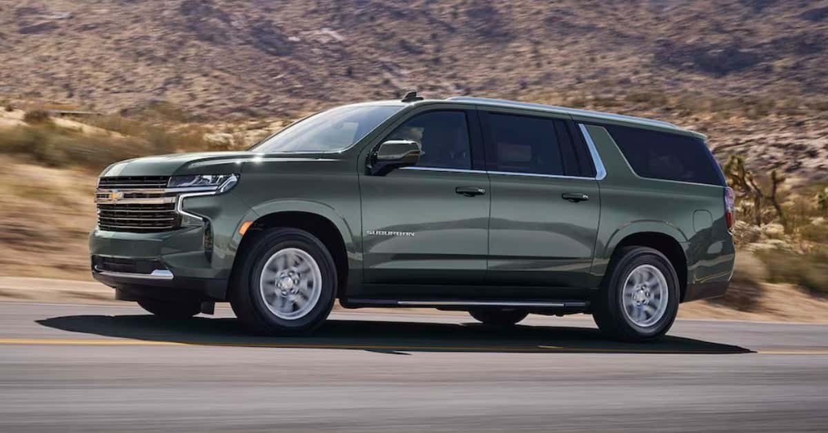 2023 Chevrolet Suburban Driving Down The Road With Desert Mountains in The Background