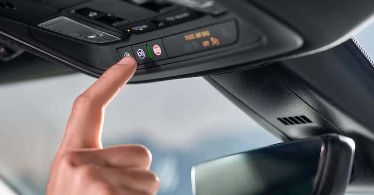 Person Pushing the Chevrolet On Star Button In A Vehicle |  2023 Chevrolet Blazer Safety Features