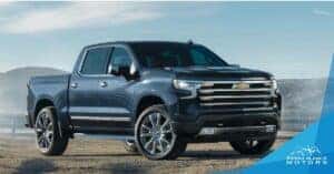 Blue 2024 Chevy SIlverado 1500 sitting on dirt at a diagonal angle.