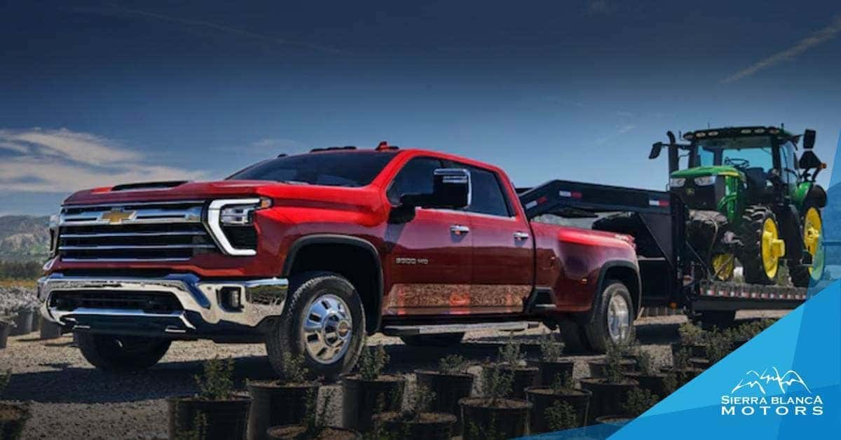 Red 2025 Chevrolet Silverado 3500 HD Towing a Tractor | Sierra Blanca Motors