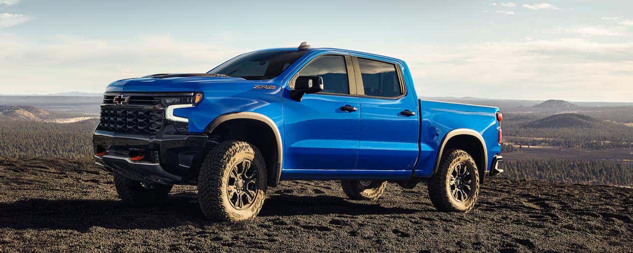 Blue Silverado atop dirt and gravel