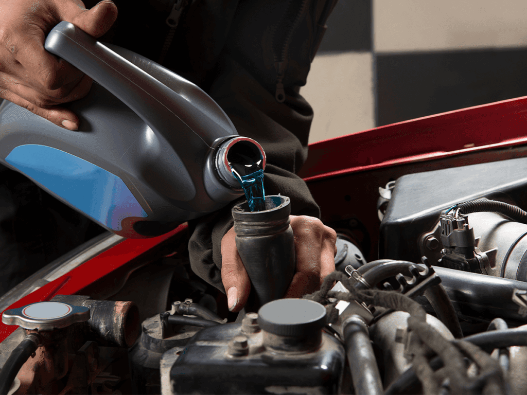 Fluids being poured into an car engine. Get your service at Spartanburg Honda.