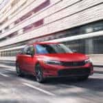 A Honda Civic driving fast through city streets.