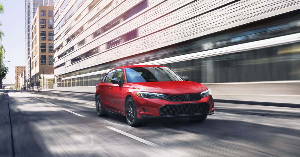 A Honda Civic driving fast through city streets.